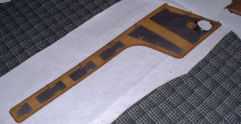 2006 Ford E350 - A tan interior trim piece, possibly from a van or truck, is shown with dark padding and a circular opening.