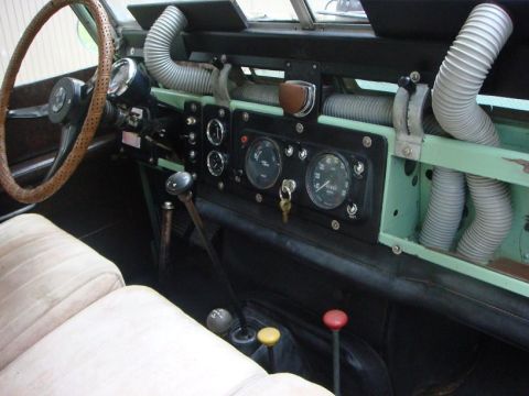 1967 Land Rover Land Rover - The interior of a 1967 Land Rover Land Rover shows its dashboard with multiple gauges, a steering wheel, and prominent ribbed hoses.