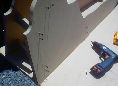 1999 Ford Taurus - A wooden console is being constructed with screws and a drill, with a yellow object in the background.