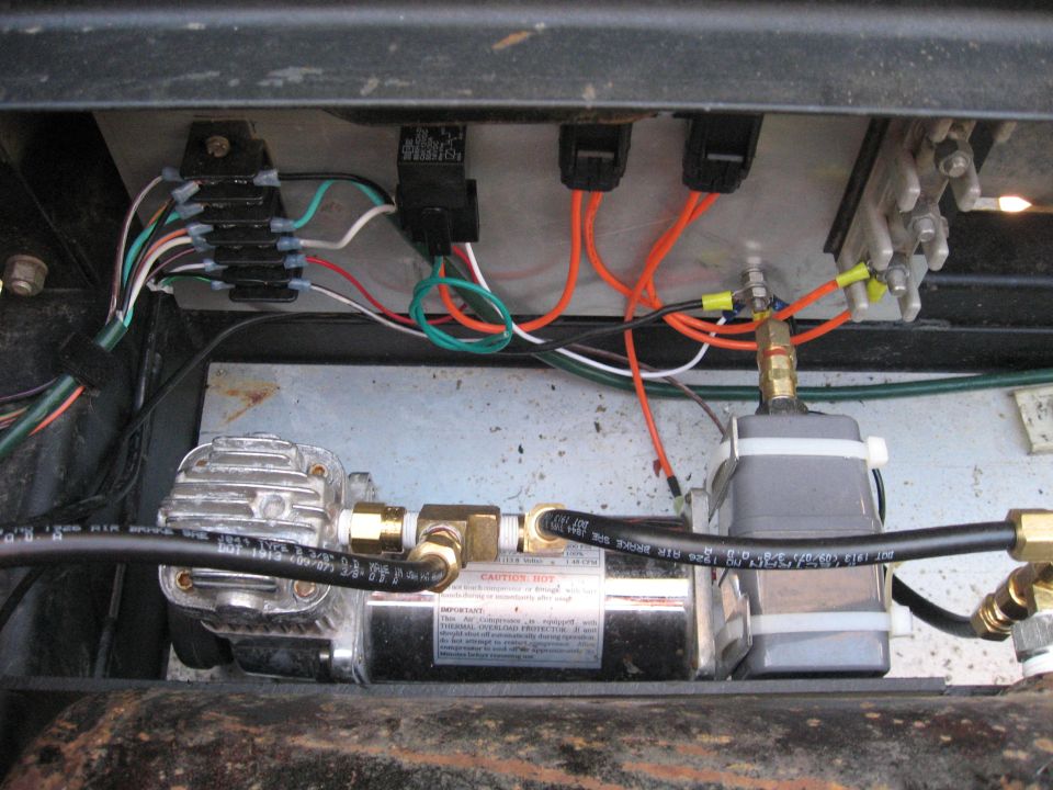 Air compressor with wiring and relays mounted in a vehicle