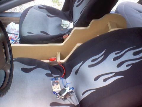 1999 Ford Taurus - Custom interior modifications include a wooden console and flame-patterned seat covers.