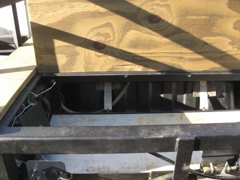 1990 Ford F-250 - Trailer storage compartment with wooden lid open, revealing internal structure and wiring.