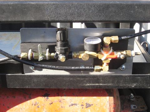 1990 Ford F-250 - Close-up of an air brake system component, a pressure gauge and control valve.