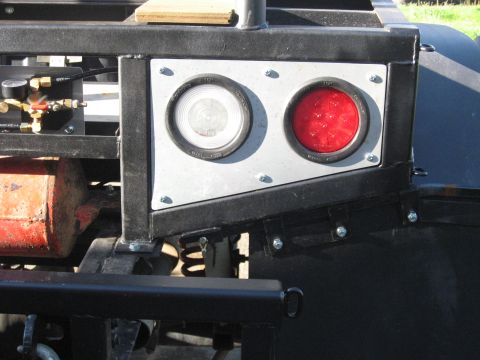 1990 Ford F-250 - Rear view of a vehicle's tail lights and trailer hitch assembly.