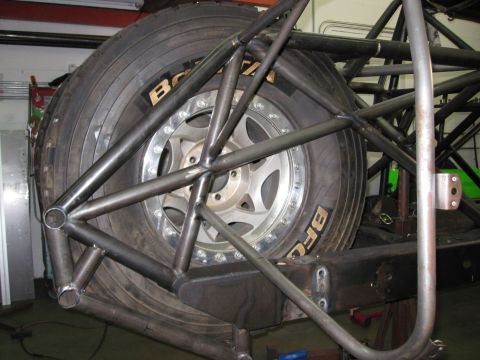 1995 Ford Bronco - Custom roll cage structure surrounds a spare tire, obscuring the vehicle's year and model.