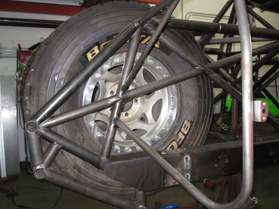Spare tire mounted within a custom metal roll cage structure