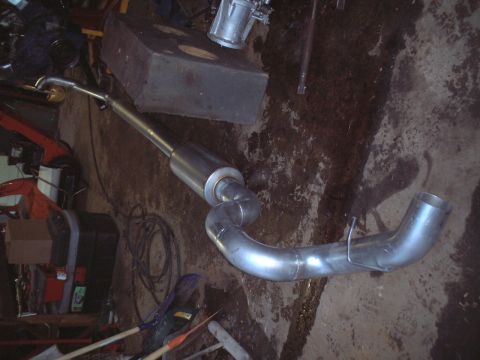 2000 Ford Excursion - Custom exhaust system component, likely for a truck or SUV, shown on the ground.