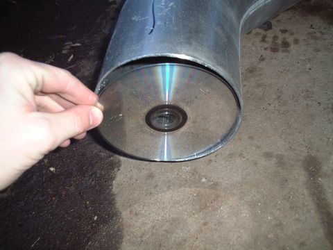 2000 Ford Excursion - A CD is placed inside the opening of a large exhaust pipe.