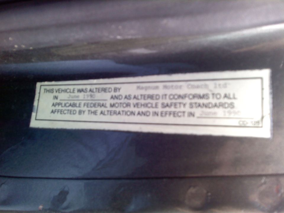 Door jamb alteration label stating the vehicle was altered by Magnum Motor Coach Ltd in June 1990