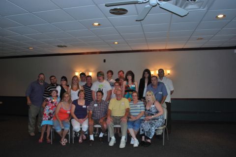 1996 Ford Bronco - A group of people are gathered together for an event, posing for a photograph in a room with a ceiling fan.