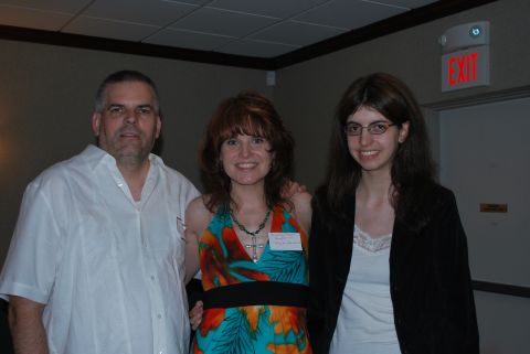 1996 Ford Bronco - A group of three individuals are photographed indoors, with an illuminated exit sign overhead.