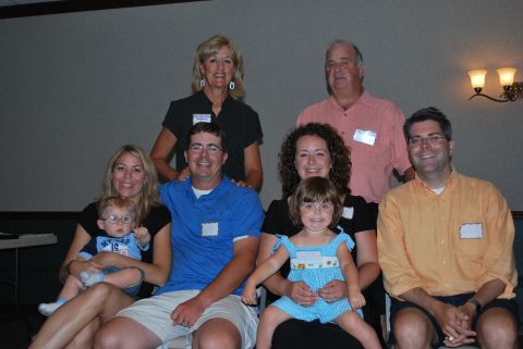 1996 Ford Bronco - A group of adults and children are gathered together for a photograph in what appears to be a banquet hall.