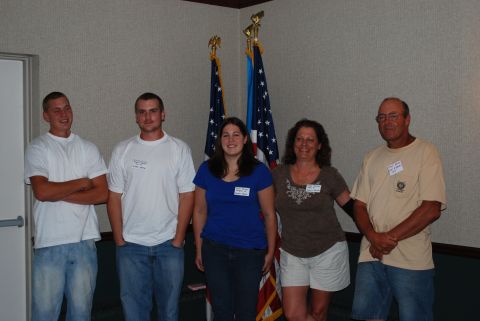 1996 Ford Bronco - A group of five individuals pose for a photo in front of two American flags, with some wearing identification tags.