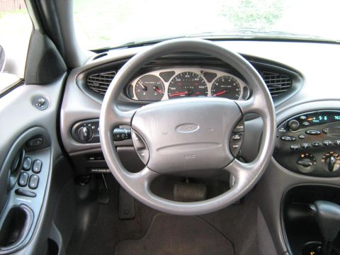 1988 Mercury Grand Marquis - The interior of a car shows the steering wheel, dashboard, and center console.