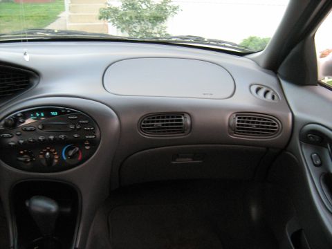 1988 Mercury Grand Marquis - The dashboard features a digital clock displaying 5:56 and radio controls.