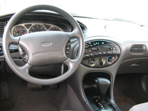 1988 Mercury Grand Marquis - Interior of a 1996 Ford Taurus, the dashboard, steering wheel, and center console.