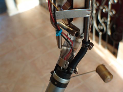 1996 Ford Bronco - Close-up view of a fuel pump assembly, including wiring and a fuel line, likely for an automotive upgrade.
