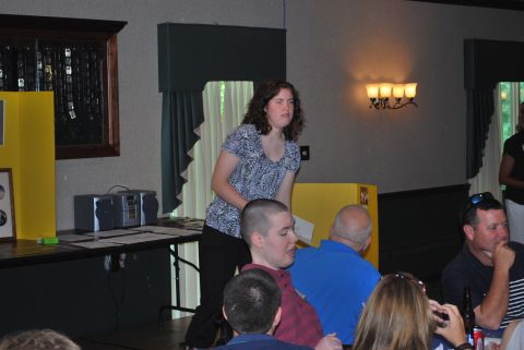 1996 Ford Bronco - A woman addresses a group of people seated at tables in a room.