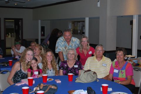 1996 Ford Bronco - A gathering of people are seated around tables, some with red cups and plates.