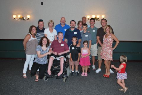 1996 Ford Bronco - A large group of family and friends gather for a reunion photo, with one individual seated in a wheelchair.