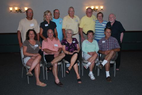 1996 Ford Bronco - A group of people, likely at a reunion, pose for a photograph in a room with decorative lighting.