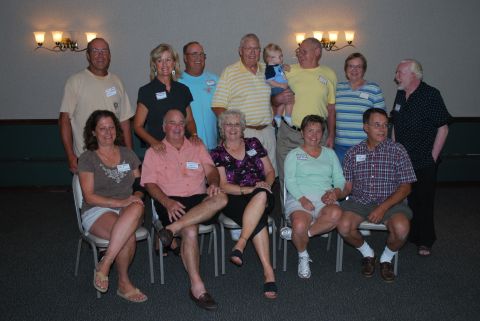 1996 Ford Bronco - A group of people, some wearing name tags, pose for a photograph, likely at a reunion event.