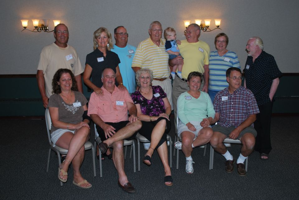 Group photo of people at a reunion, some wearing name tags