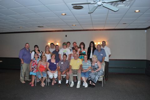 1996 Ford Bronco - A large group of people are gathered together for a photo in a room with a dropped ceiling and fluorescent lighting.