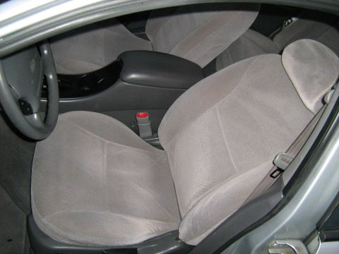 1988 Mercury Grand Marquis - Interior view of a car, showing the front seats, steering wheel, and armrest.