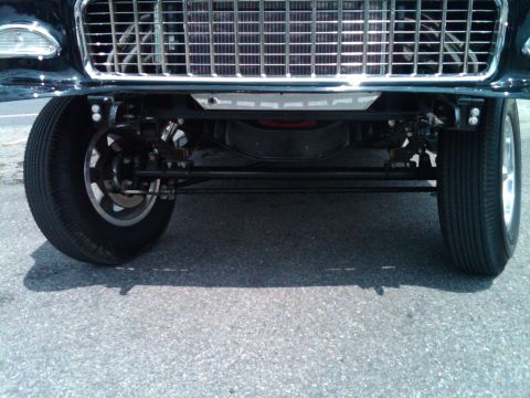 1955 Chevrolet Bel Air - The distinctive grille and front suspension of a 1955 Chevrolet Bel Air are visible.