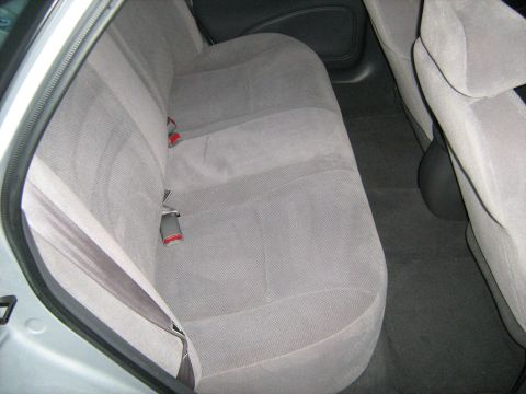 1988 Mercury Grand Marquis - Interior view of a car's back seat, showing gray upholstery and seatbelts.