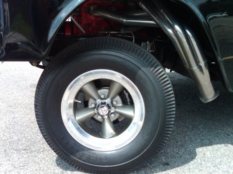 1955 Chevrolet Bel Air - Custom wheel and exhaust system on a hot rod, showing 'Wilwood' branding on the brake caliper.