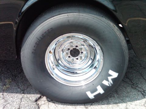 1955 Chevrolet Bel Air - Close-up of a drag racing tire and chrome wheel with 'HW' painted on the sidewall.