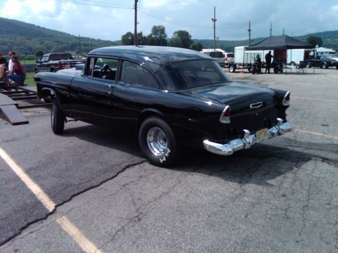 1955 Chevrolet Bel Air - Black 1955 Chevrolet sedan with chrome bumpers and drag racing tires.