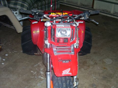 1991 Ford Bronco - This red Honda ATV features large rear tires and a prominent front headlight assembly.