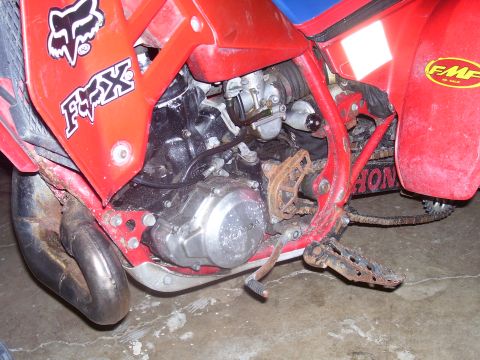 1991 Ford Bronco - Detail shot of a Honda dirt bike's engine and frame components, including a Fox logo.