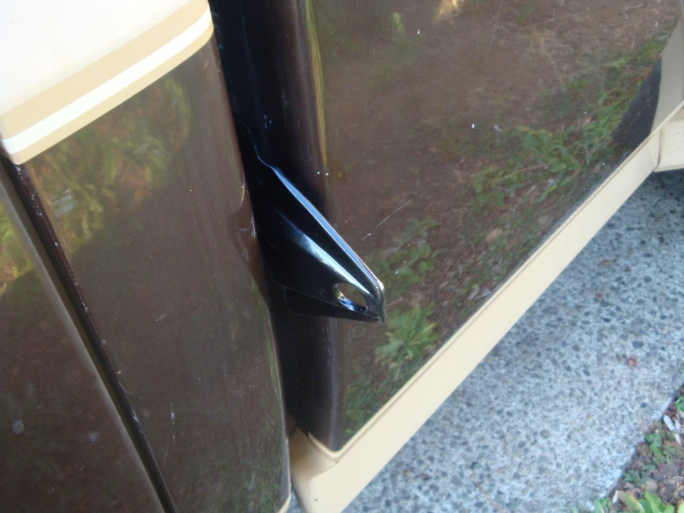 Brown and tan truck door with black handle and chrome trim