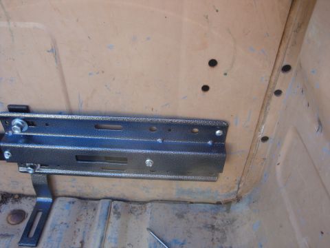 1988 Ford F-350 - A metal bracket is installed inside a vehicle's cabin, showing the interior's worn surfaces.