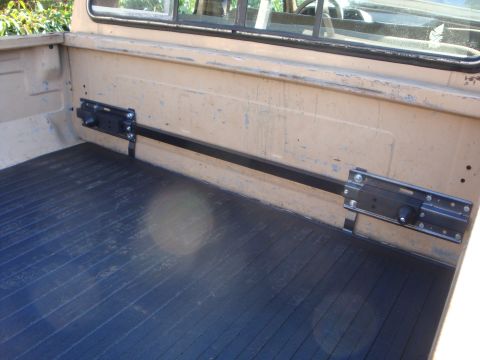 1988 Ford F-350 - Interior view of a truck bed adjustable tie-down rails.