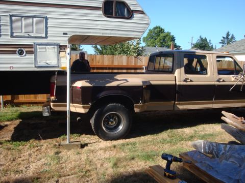 1988 Ford F-350 - This two-tone brown and tan pickup truck appears to be a 1987 Ford F-350, equipped with a camper shell.