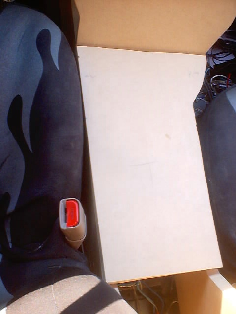 1999 Ford Taurus - Interior view of a car, focusing on the seatbelt and a box placed on the seat.