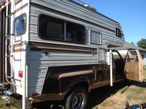 1988 Ford F-350 - Ford F-350 pickup truck fitted with a camper shell, viewed from the side with the driver's door open.