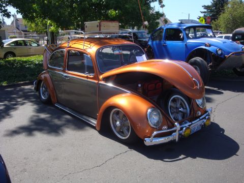 1964 Ford Fairlane - A custom two-tone Volkswagen Beetle is displayed with its hood open, its engine and spare tire.