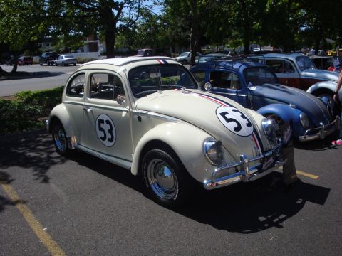 1964 Ford Fairlane - A classic Volkswagen Beetle, often called a "Bug", is displayed at a car show with other vehicles.