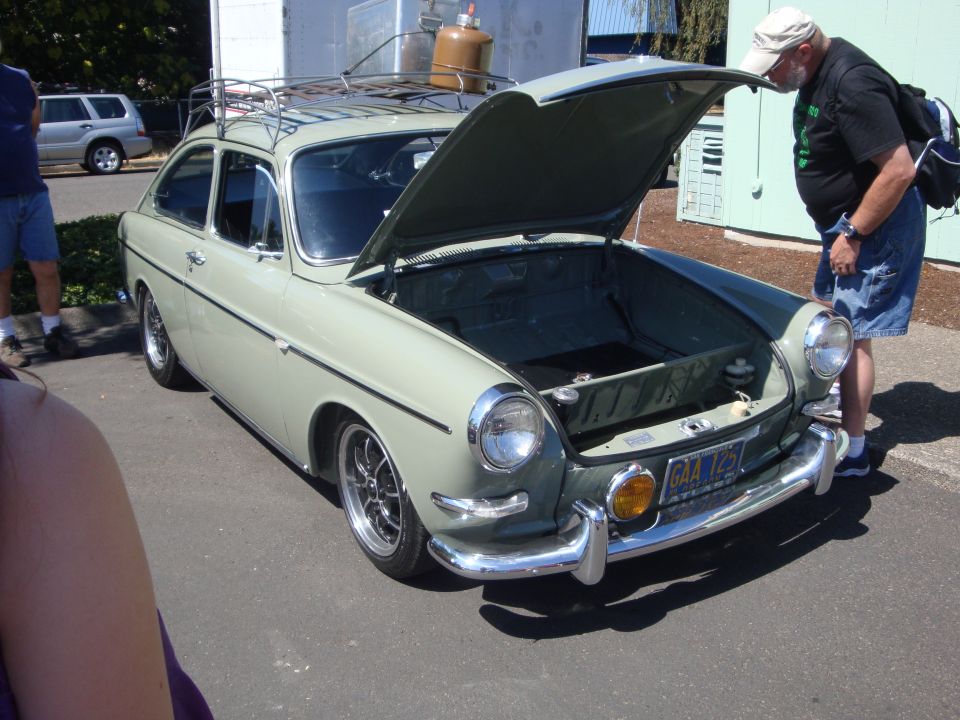 Light green Volkswagen Type 3 Fastback front view, hood open, roof rack