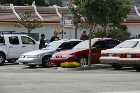 1990 Ford Taurus - Several cars are parked in front of a McDonald's restaurant.