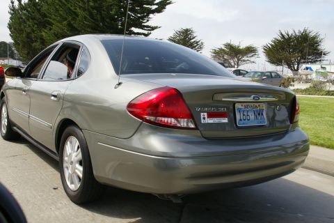 1990 Ford Taurus - This silver sedan, identified as a Taurus SEL, is seen from the rear with a Nevada license plate.