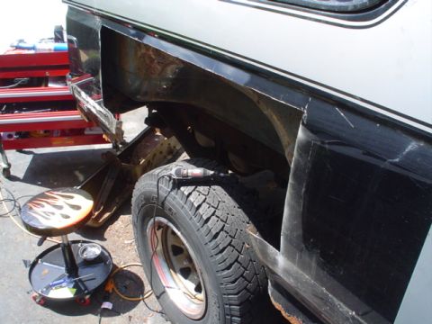 1988 Ford Bronco - This vehicle is undergoing body repair, showing significant rust and damage to the rear quarter panel.