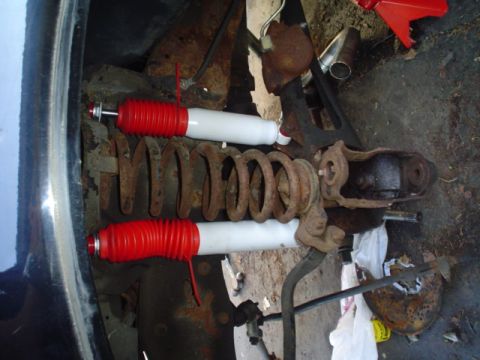 1988 Ford Bronco - Close-up view of vehicle suspension components, including coil springs and shocks.