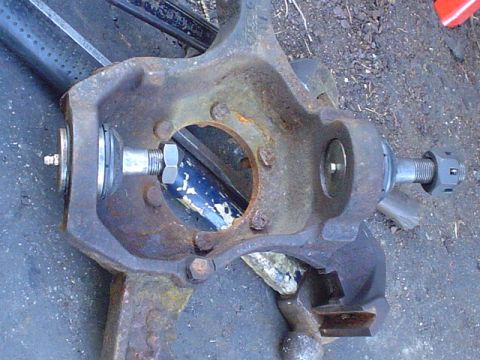 1988 Ford Bronco - A close-up view of a vehicle's suspension component, showing rust and mechanical fasteners.